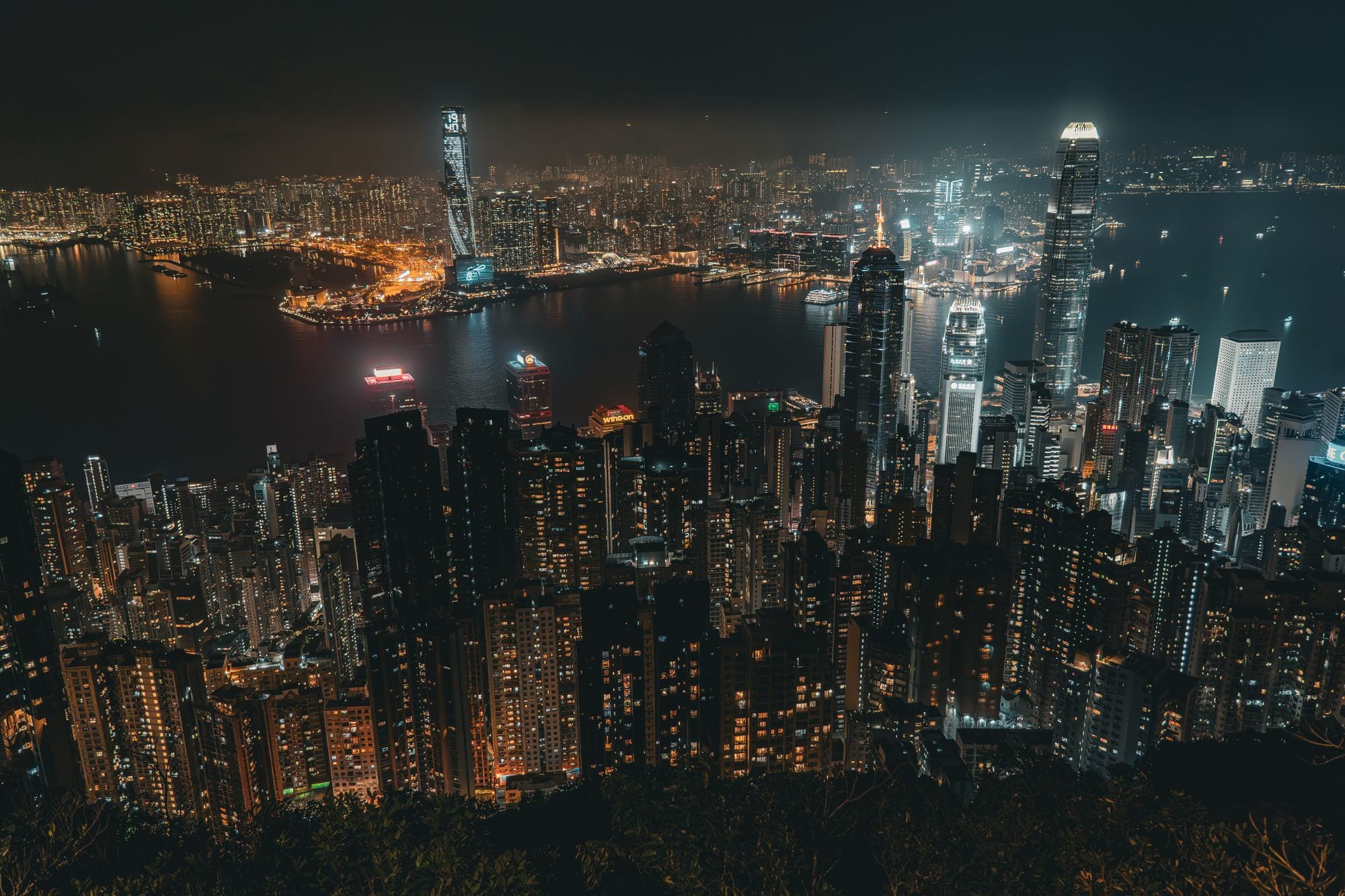 Hong Kong's skyline and Victoria Harbour glittering at night from the Peak