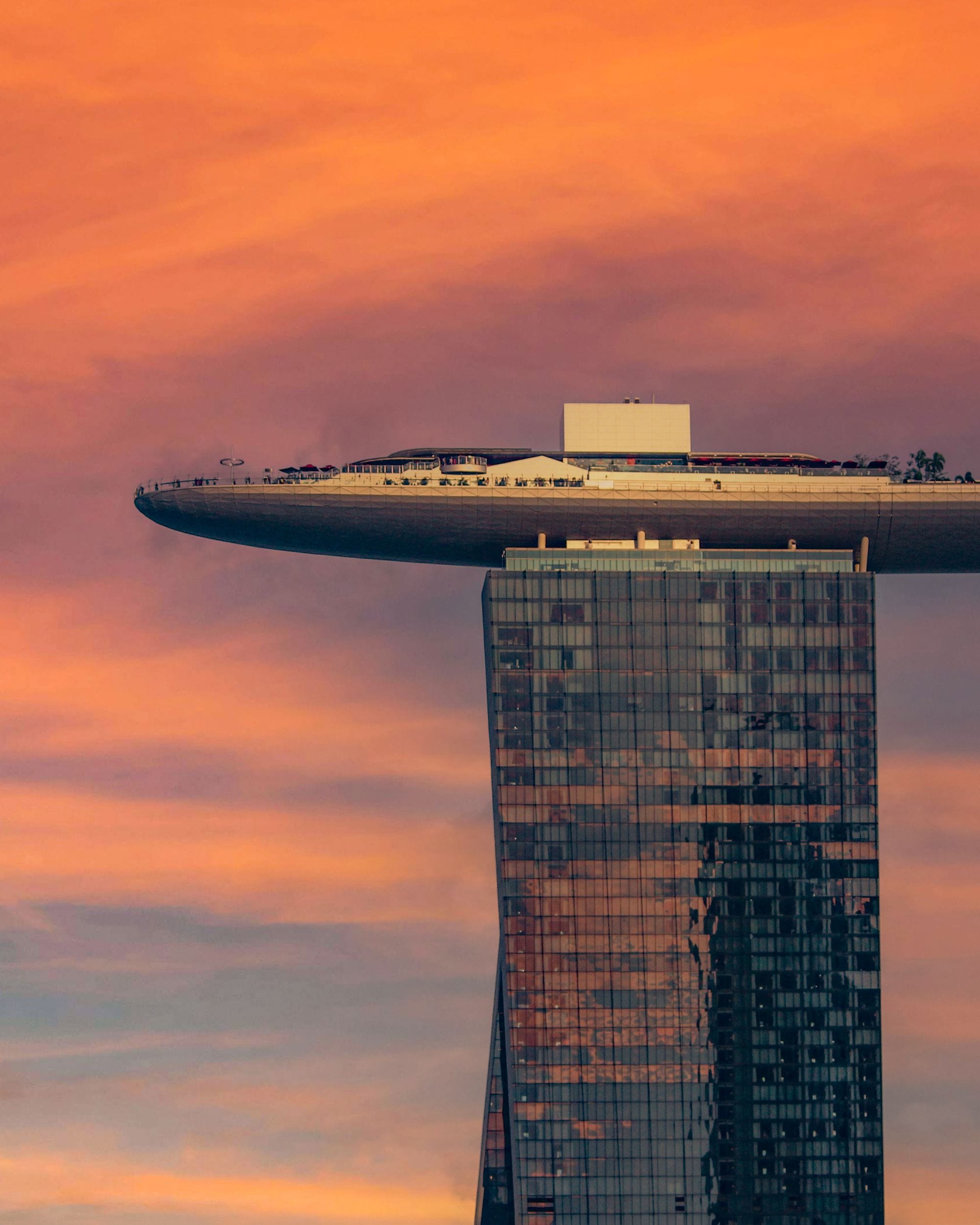 Marina Bay Sands' SkyPark deck glows against a fiery twilight sky over Singapore