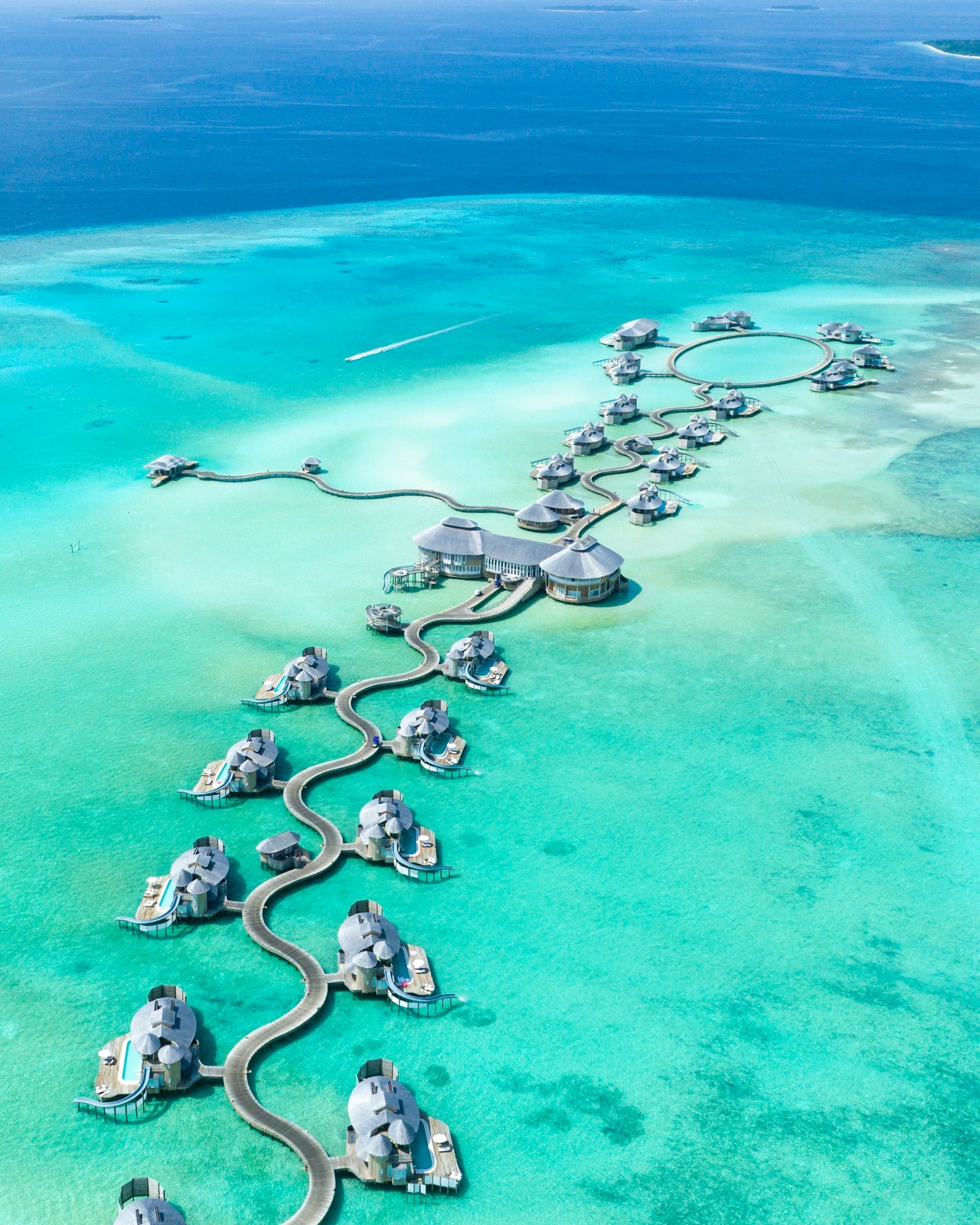 A Maldivian atoll ringed in shallow turquoise water