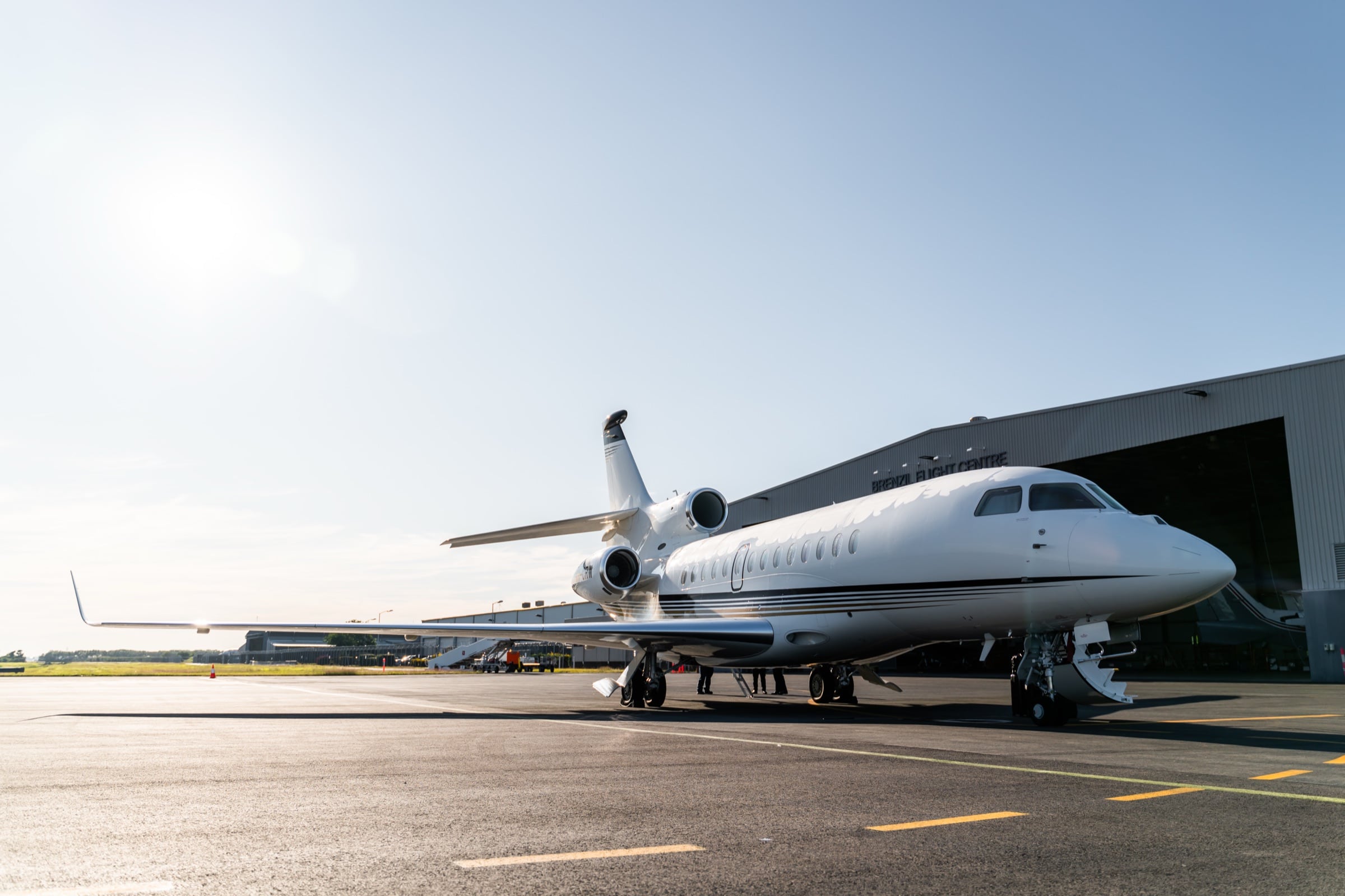 A Dassault Falcon 7X waiting on the apron in morning light
