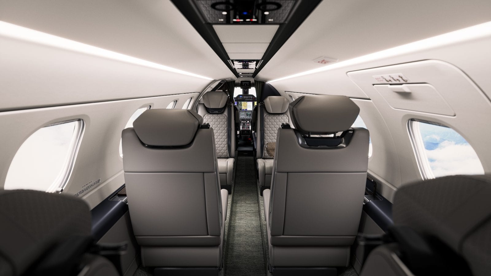 The Phenom 300EV cabin looking forward to the flight deck — quilted grey seats beneath a bright two-tone ceiling