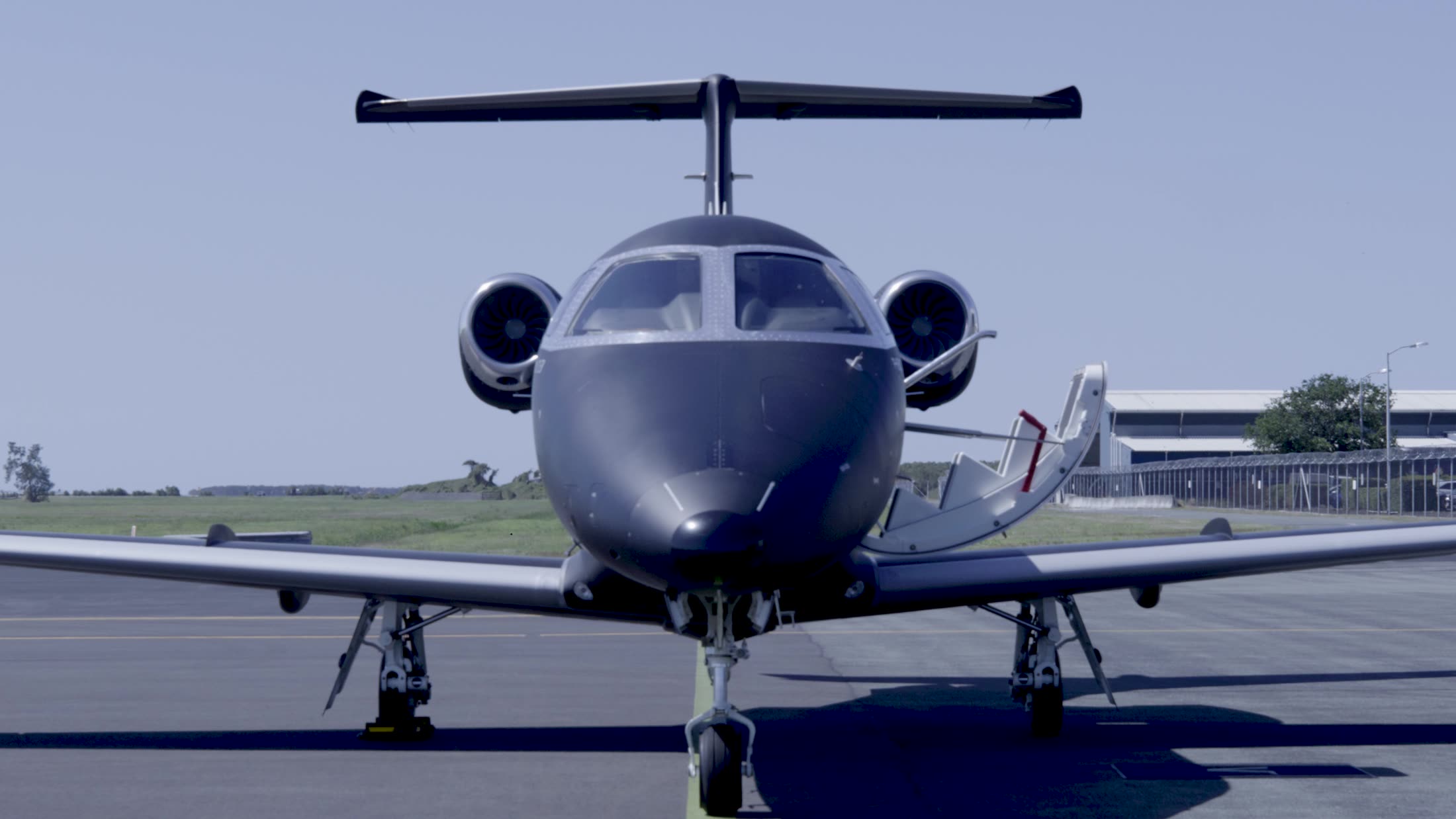 A private jet head-on under clear skies