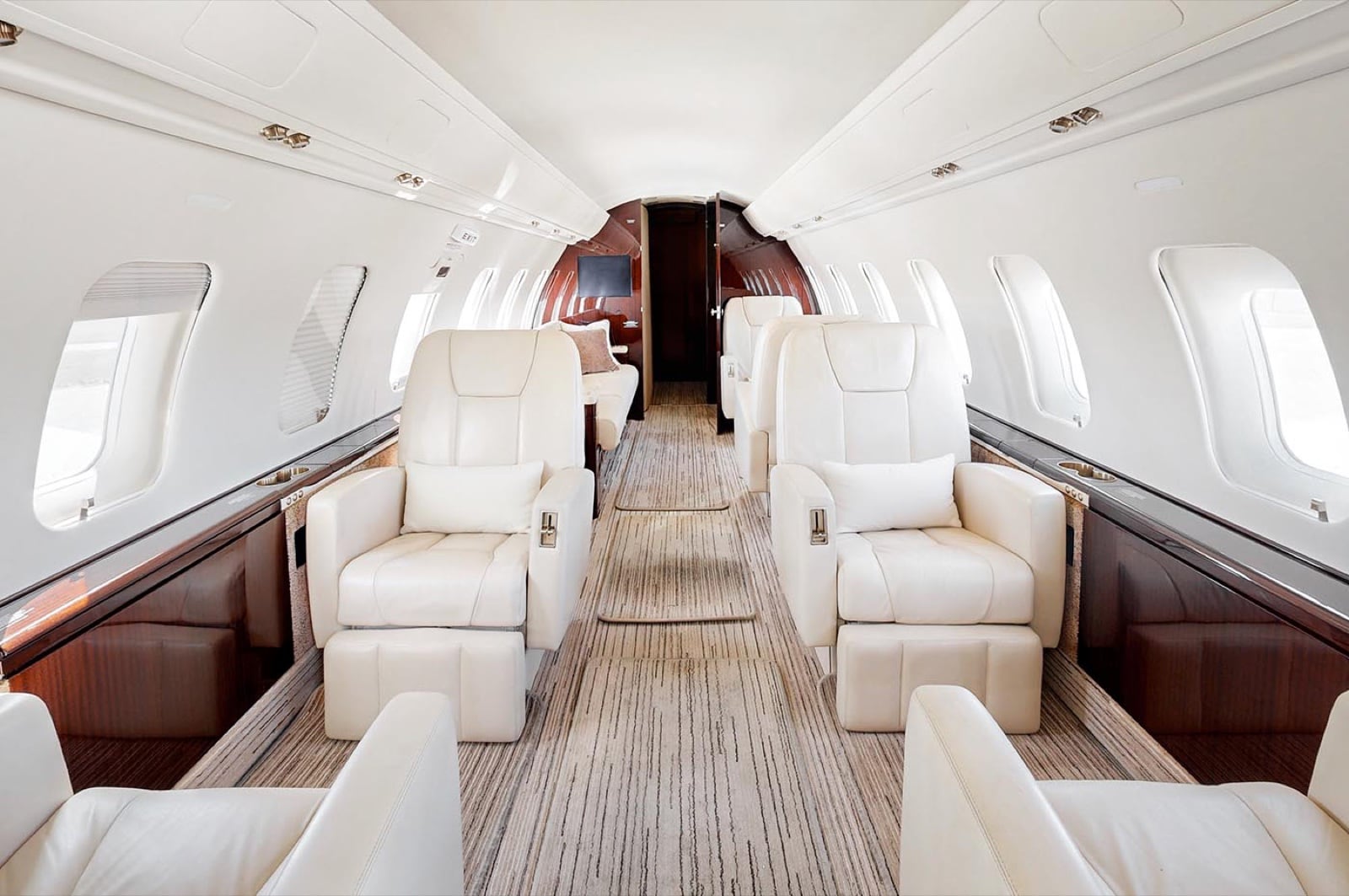 The Challenger 605 cabin — cream club seating across the class's widest cross-section