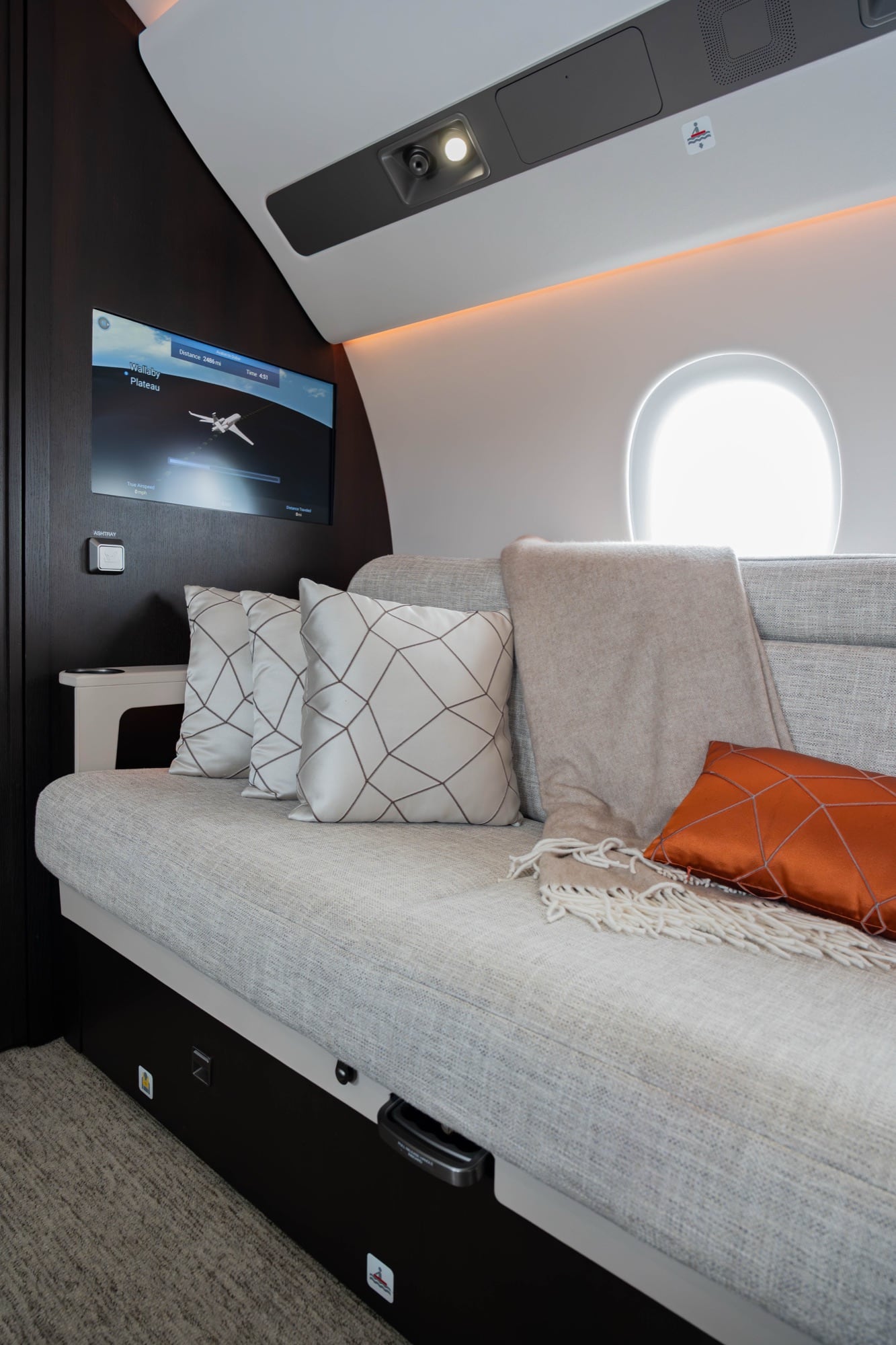 Facing divans in a Falcon 8X cabin, dressed for the evening leg