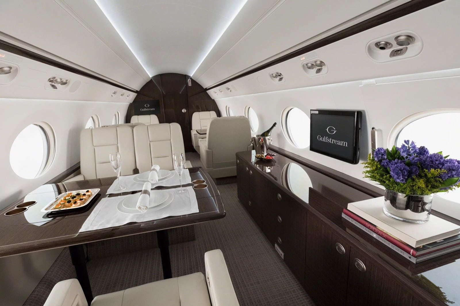 The G550 cabin set for dining, beneath Gulfstream's signature oval windows