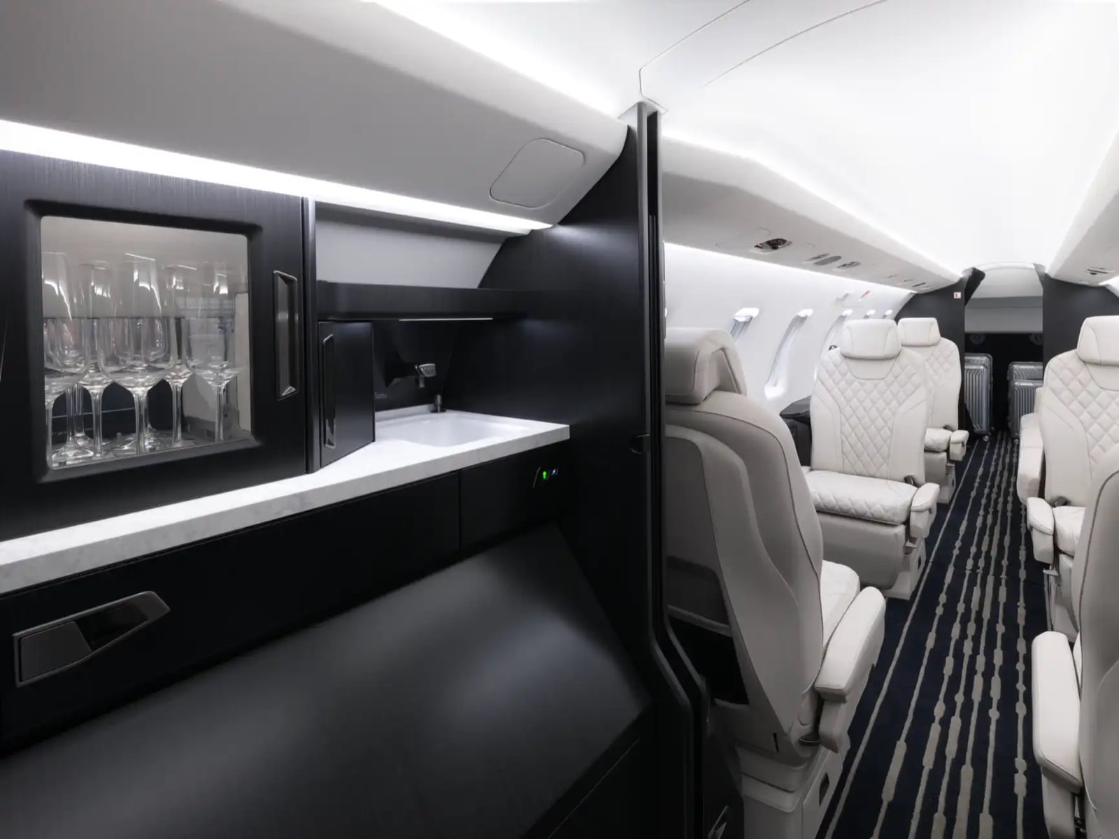 The PC-24 cabin — quilted seats beside the refreshment bar
